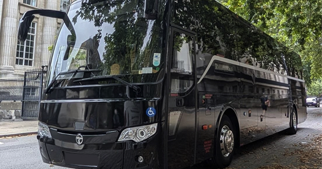 Black executive coach on a city street