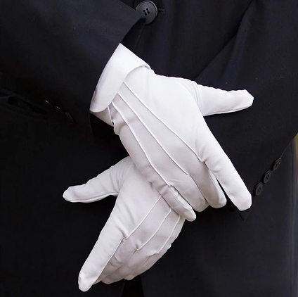 Chauffeur in formal suit with white dress gloves
