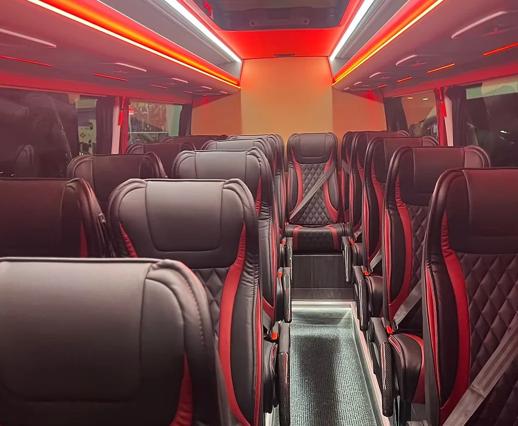 Luxury coach interior with leather seating and ambient lighting