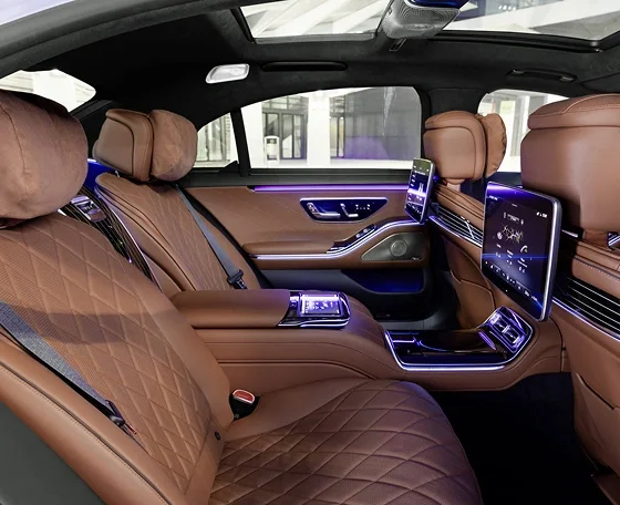 Rear cabin of a luxury saloon with quilted leather, rear screens and ambient lighting