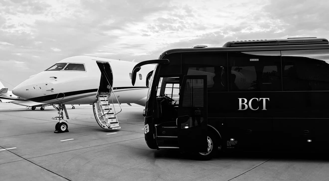 Private jet on the tarmac with BCT luxury coach shuttle for executive airport transfers